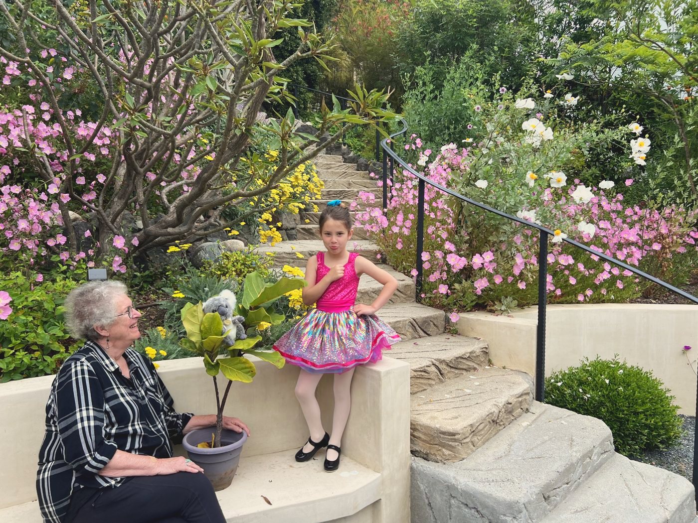 Lee in a garden with a granddaughter in a tutu