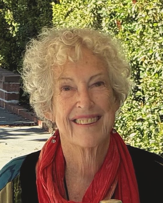 Lee Somerville, smiling, in a red scarf
