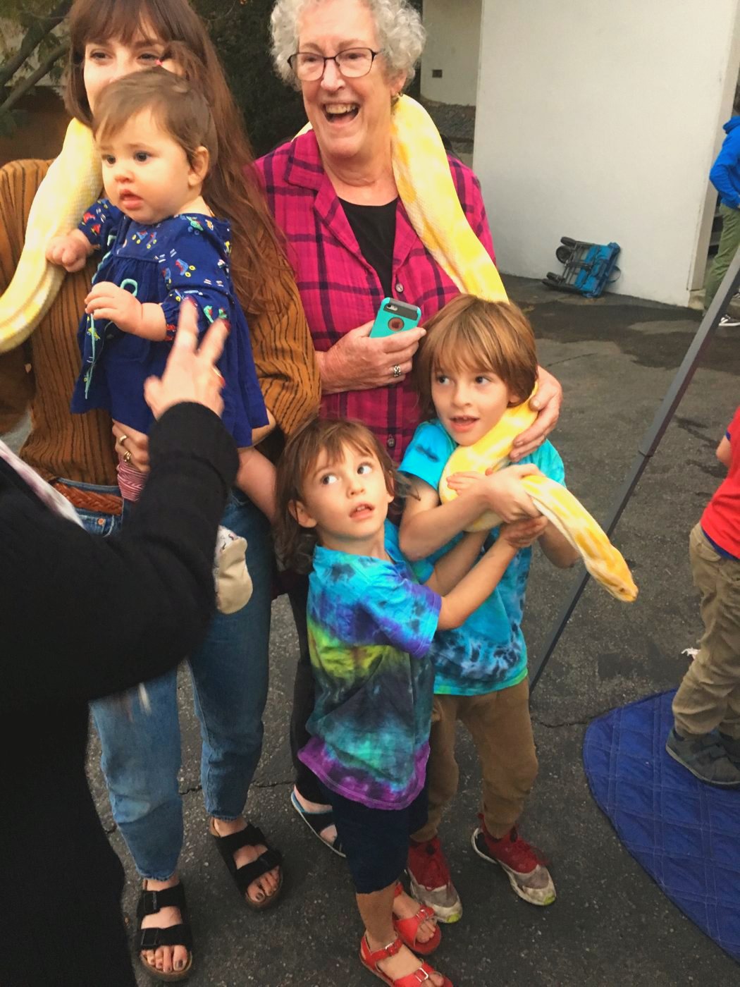 Lee, delighted, wearing a python, with the grandchildren
